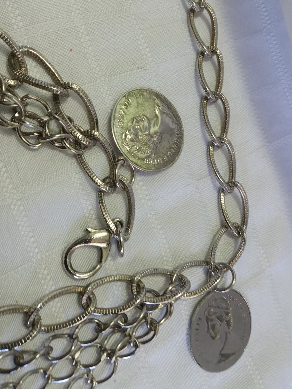 Vintage metal belt with many row and false money pieces in a silver color
